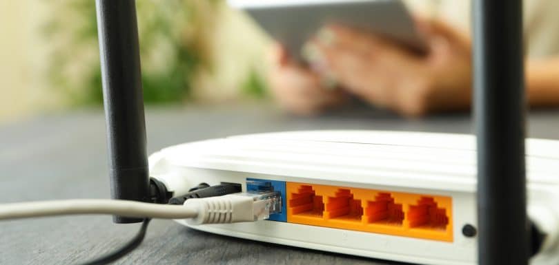 Wi - fi router on gray wooden table, close up, wireless wifi router work