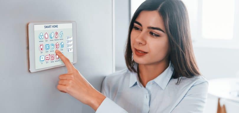 Woman is indoors controlling smart home technology, residential network cabling