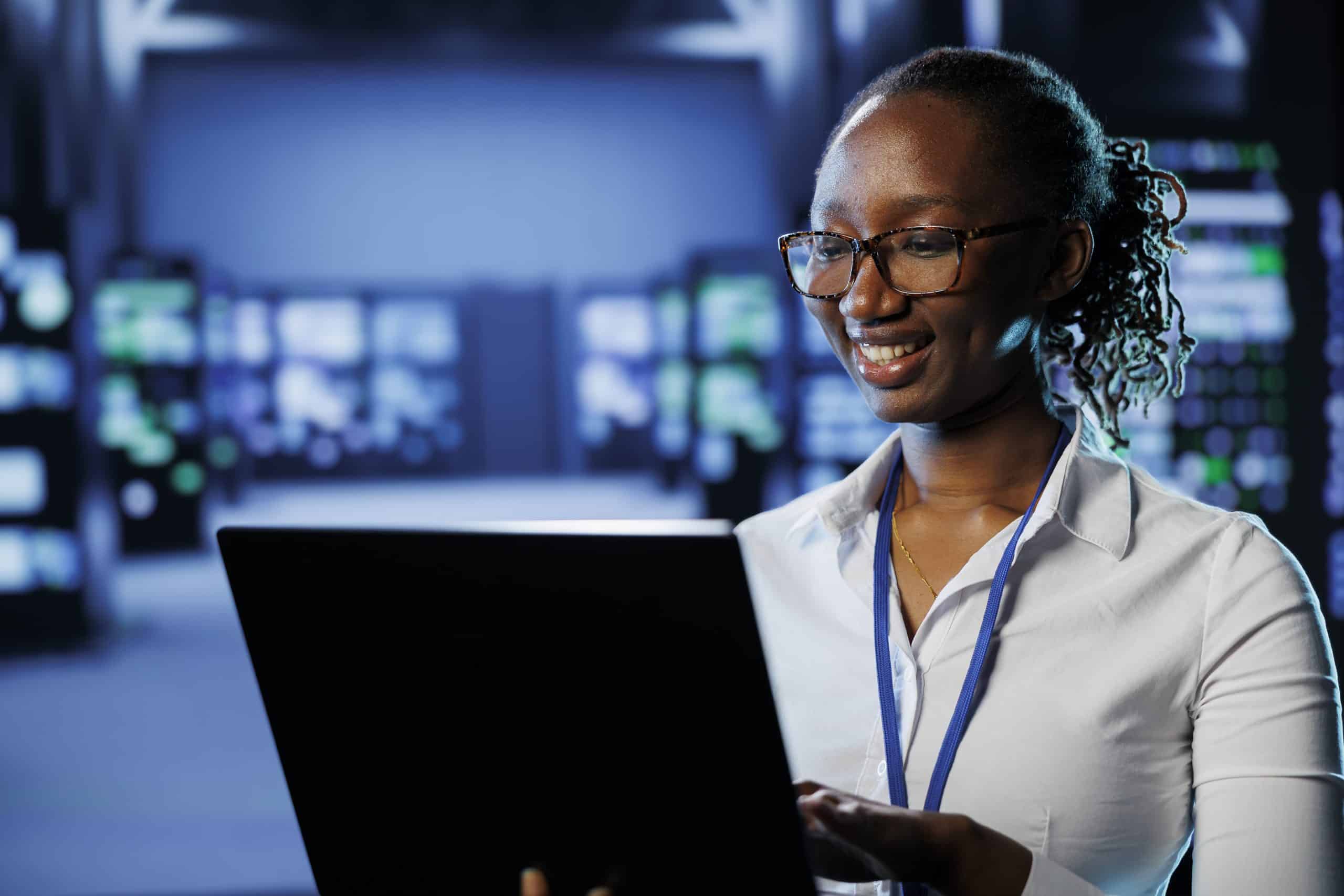 Woman in data center with laptop