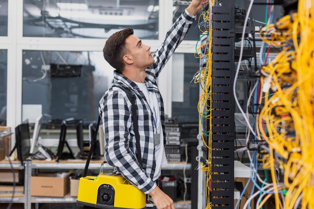 young network engineer working with structured cabling