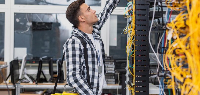 young network engineer working with structured cabling